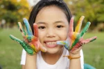 Asian,Little,Girl,With,Hands,Painted,In,Colorful,Paints